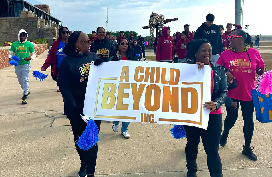 A Child Beyond Inc. community members carrying the organization banner